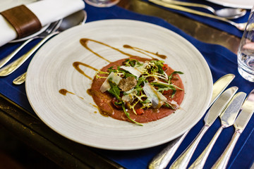 Meal with dressing and sauce on the dish in restaurant