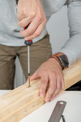 close up of hands of  man using screwdriver