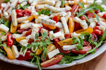 Salad with tomatoes, blue cheese, arugula and sunflower seeds