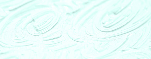 The texture of the paint is blue. Background with a picture of leaves and flowers.