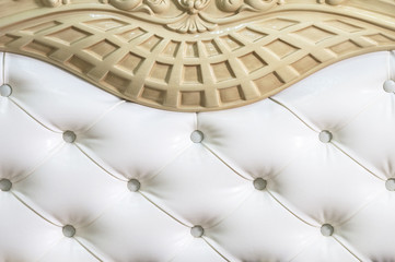 Obraz premium Close-up white fabric upholstered headboard with buttons textile background, retro Stylish bedroom furniture