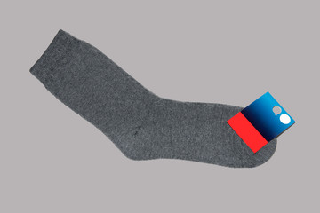 Warm wool sock on grey background with label