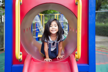 Fototapeta na wymiar cute asian girl happy play in play park outdoor park