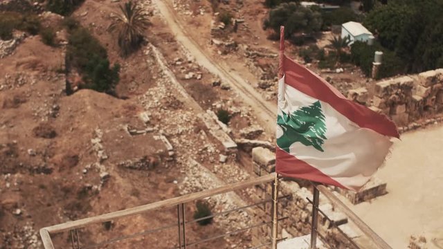 Lebanon flag between the roman ruins.