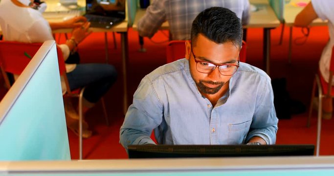 Executive using desktop pc at desk 4k