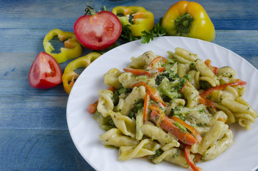 Pasta with vegetables and cheese on a blue background vegetables on the background