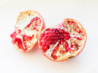 Big Ripe Red Granet or Garnet. Fruits of Red Ripe Pomegranate on the White Background. Vegetarian Concept, Organic Vitamins, Detox, Diet. Organic and Benefit Garnet Fruit. Open Garnet.
