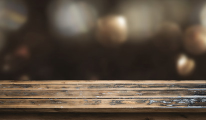 Dark christmas bokeh background with wooden table