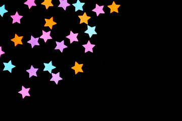 Event background: colorful stars, black background, free copy space, perfect for a birthday, parties etc