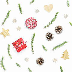 Christmas composition. New Year's wooden toys, fir cones, fir branches, gift twine, red gift on white background. Christmas winter decoration, Nature New Year concept. Flat lay, top view.