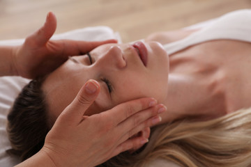 Woman enjoying head massage. Acupressure, reiki healing treatment. Relaxation and Alternative medicine concept - obrazy, fototapety, plakaty