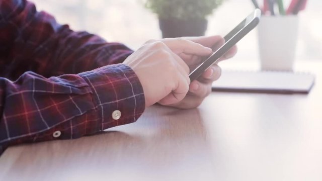 man interacting with his phone. emailing, texting,