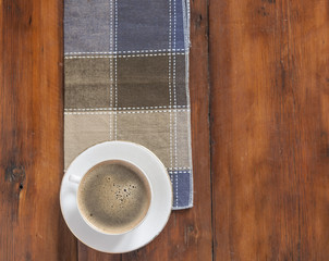 White cup of coffee on vintage wood. Top view.