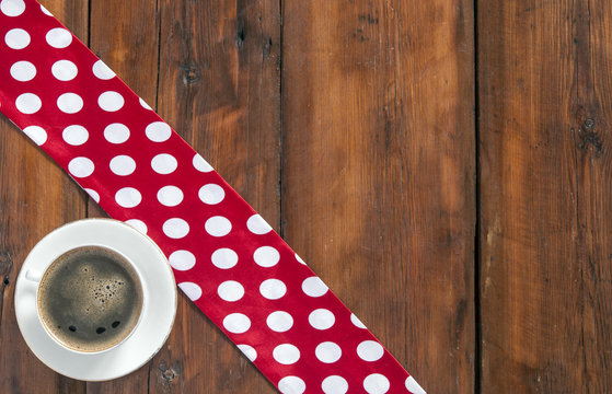 White cup of coffee on vintage wood. Top view.