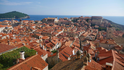 Fototapeta na wymiar View of the historic city of Dubrovnik. View from the city walls to the medieval old town, buildings dating from the Middle Ages located by the sea. A frequent place of turistic tours.