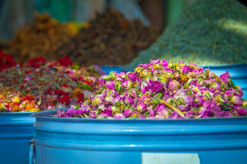 Large iron barrels of blue with dried flowers on the market in the medina of Marrakesh. Africa Morocco