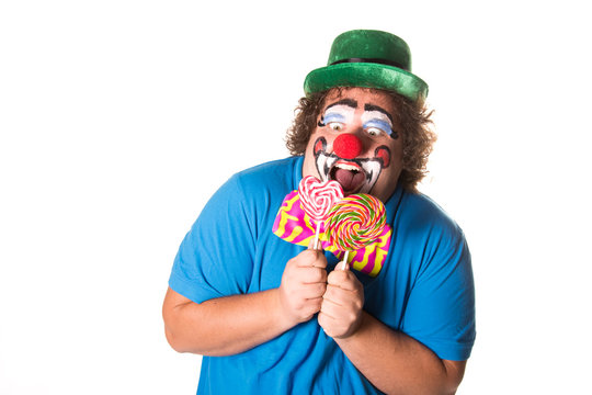 Funny clown. Fat man with candy. White background.