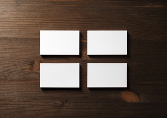Photo of blank business cards stacks at wood table background. Template for branding identity. Flat lay.
