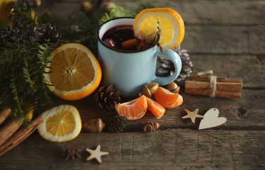 christmas hot mulled wine with cinnamon cardamom and anise on wooden background