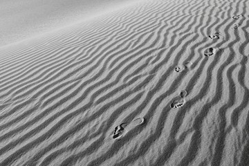 Minimalism -Humans foot prints in the sand, black and white background