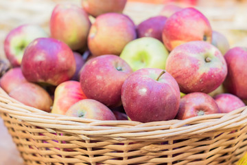 close up of red ripe apples in a basket at the farmer's market