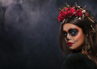 Creative image of Sugar Skull. Neon makeup for Halloween or Dia De Mertos holiday.
