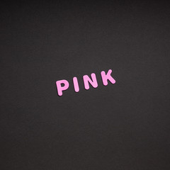 Pink writing on black paper background