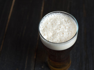 Cold nitrogen beer with a large foam cap