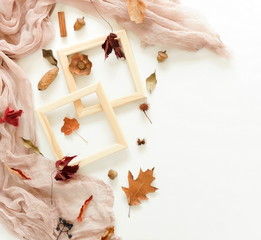 Autumn composition background. Artist home office desk workspace ,  paint brushes, frames, autumn leaves on  white background. Flat lay, top view creative minimal mock up template.  Copy space