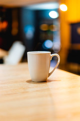 White coffee or tea mug on a wooden desk