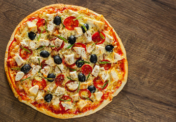 Pizza with Chicken meat, Mozzarella cheese, tomato, olive. Italian pizza on wooden background