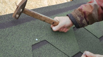 Repair of the roof of a residential house. installation of soft tiles. partial replacement of the damaged roof. Dot repair.