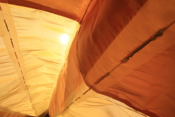 Orange see through fabric with the sun on the background