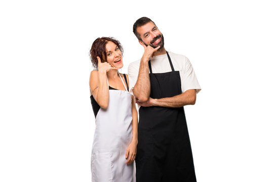 Couple of cooks making phone gesture. Call me back sign on isolated white background