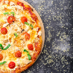 Pizza with chicken and tomatoes on a grey background. space for text