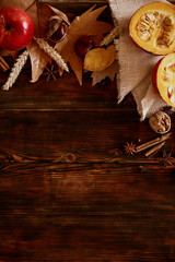 Thanksgiving background concept. Local produce pumpkin, apples & autumn leaves with other fruits, berries & vegetables for decoration on wood textured table. Close up, copy space, top view, flat lay.