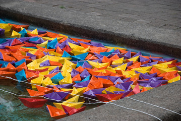 multicolored folded paper boats in pool