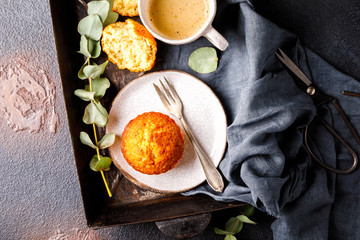 Muffin snack and a cup of coffee on the background baking tray.Copy space for Text.