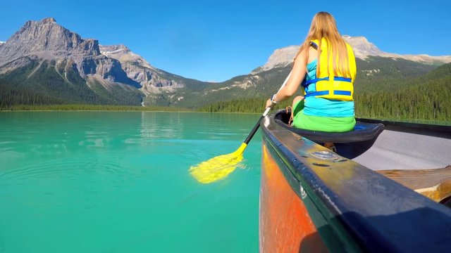 Woman rowing a boat on river 4k