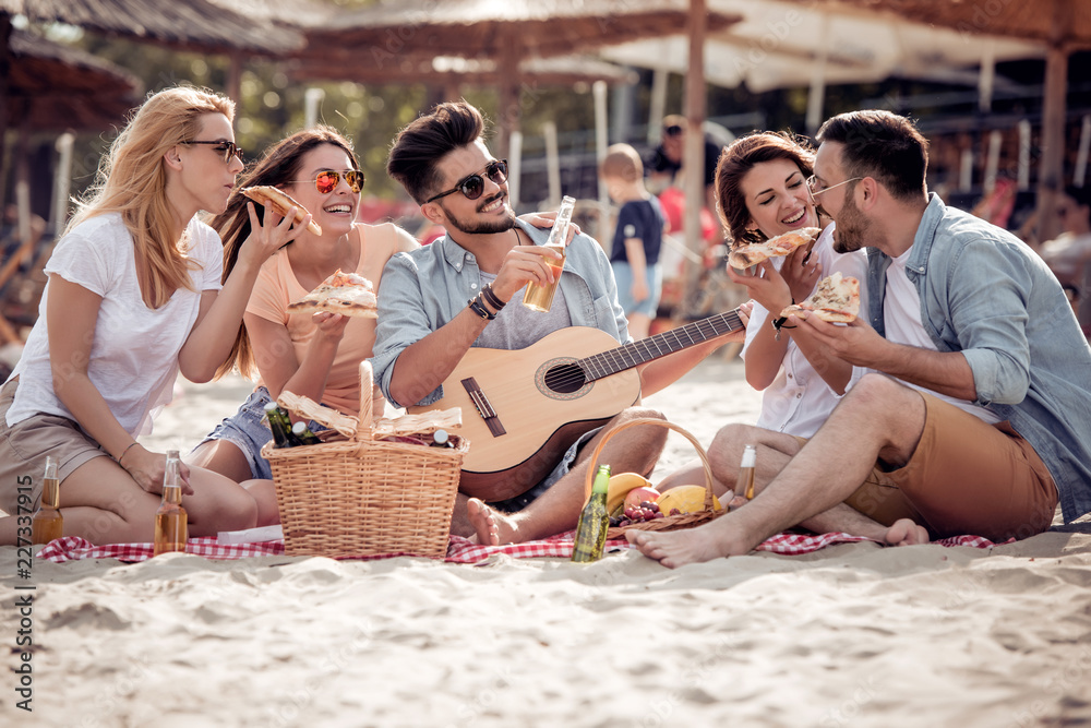 Wall mural group of friends having a party on the beach