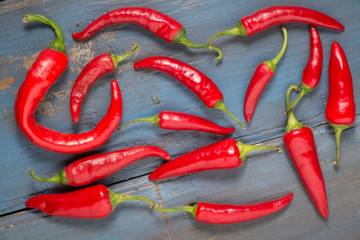 Red hot chilli peppers on a gray board table. Top view