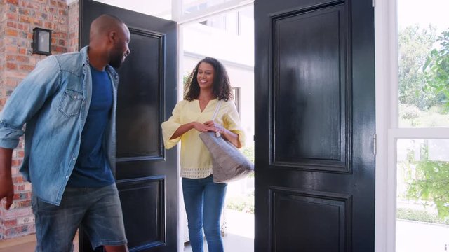 Young mixed race couple arriving at home