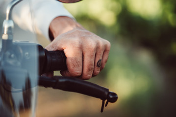 Man Grips Motorcycle Handle 