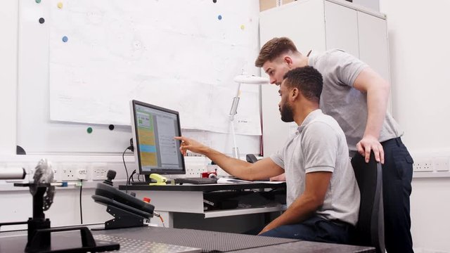 Two Male Engineers Uses CMM Coordinate Measuring Machine In Factory