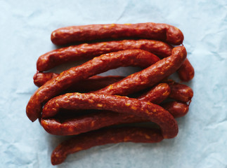 Lots of fresh beef sausages on paper top view