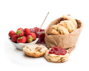 Traditional  scones with fresh strawberries and jam isolated on white