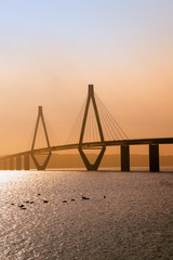 Fototapeta na wymiar faro bridge in sunset light, the highway bridge over the Storstroem in denmark connects the islands and is a part of the vogelfluglinie (bird flight line), copy space