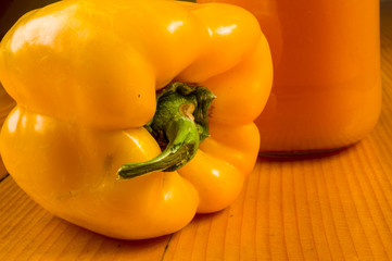 fresh yellow paprika, bell pepper and a bottle of pumpkin juice