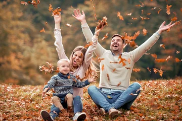 Foto op Canvas happy family in autumn park © ivanko80