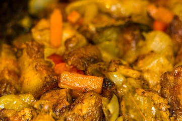Roast meat, onions, carrots and spices, boiling in oil